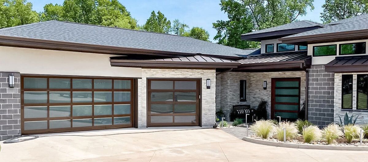 A large house with two garage doors and a driveway.