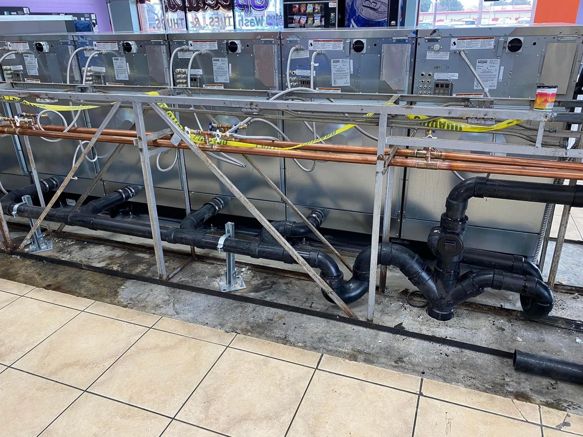 A row of pipes are connected to a metal structure.