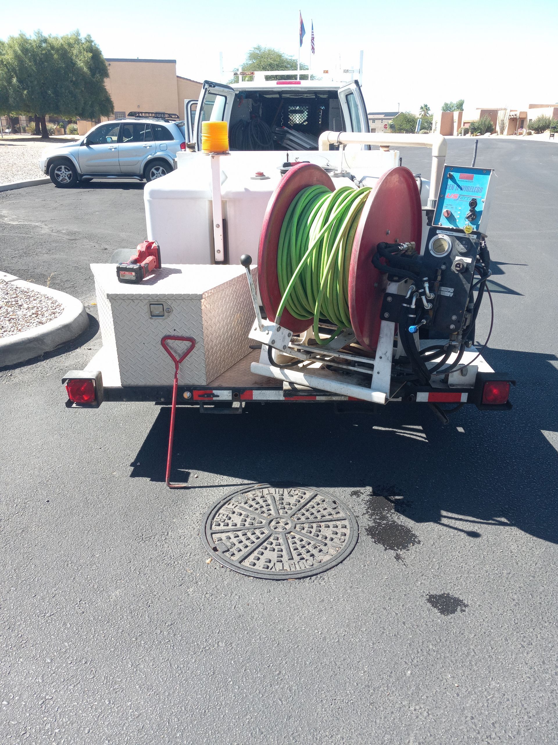 A hose reel is attached to the back of a truck