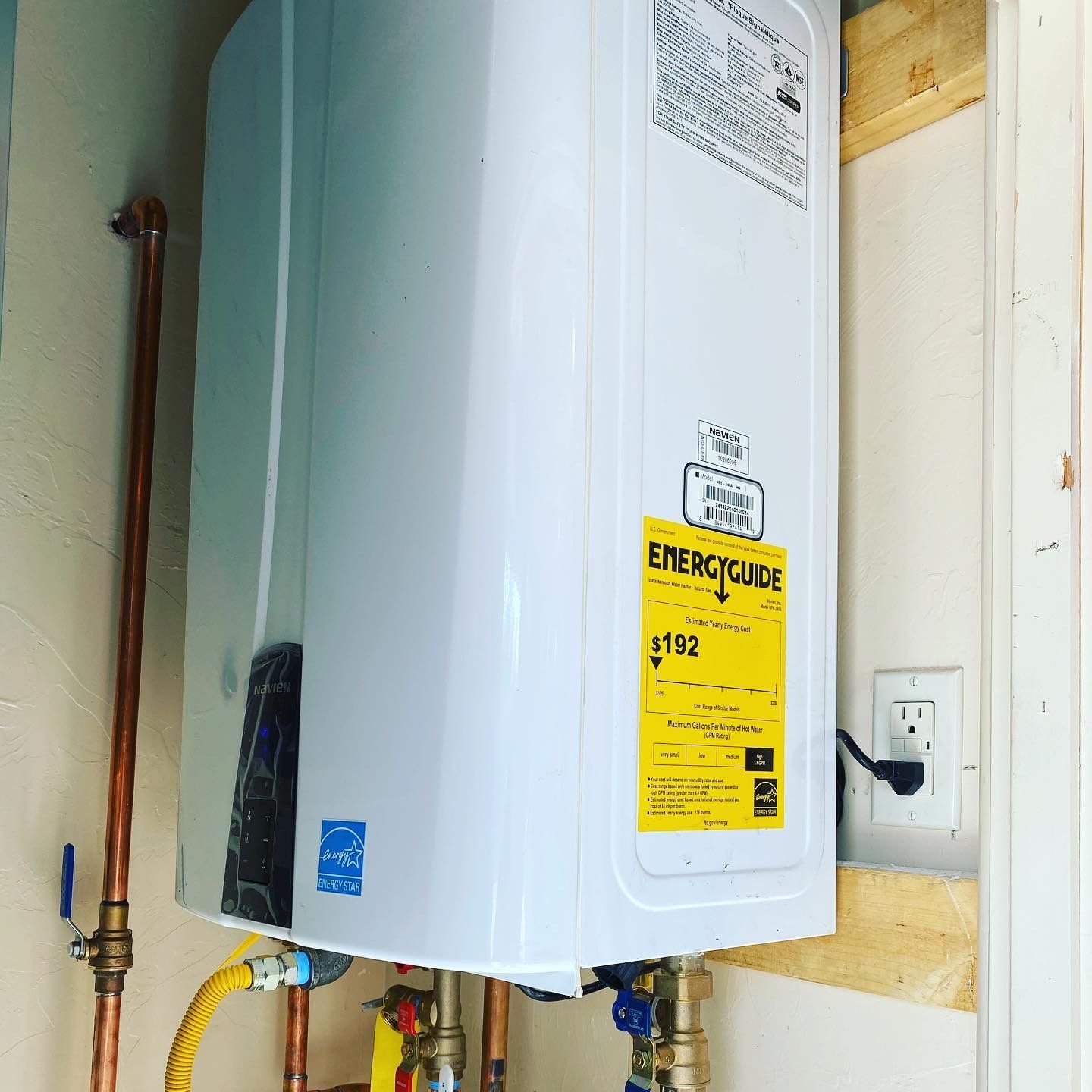 A white water heater with a yellow energy label on it