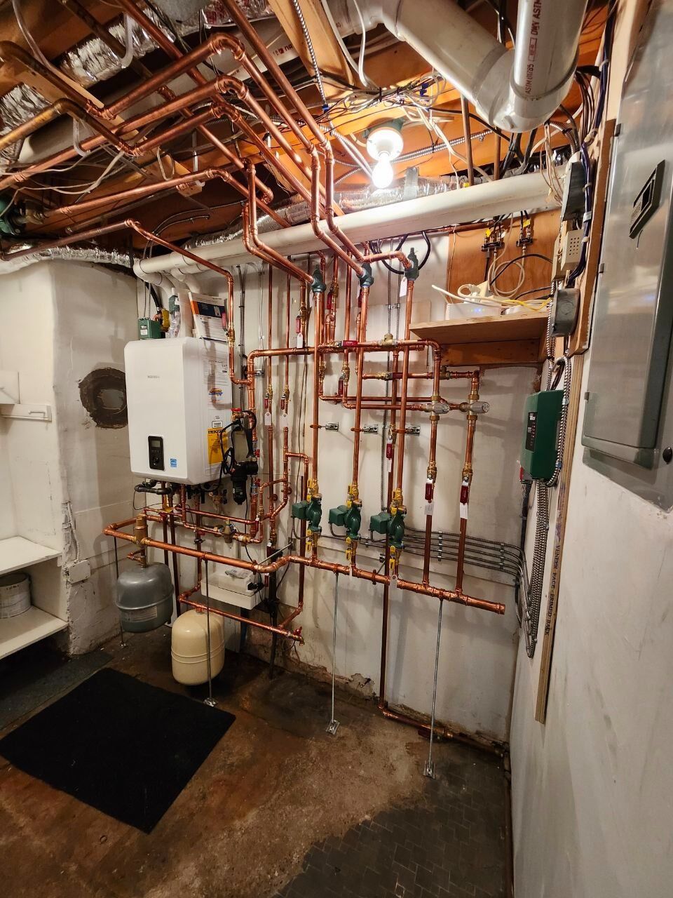 Copper pipes and heating equipment in a basement.