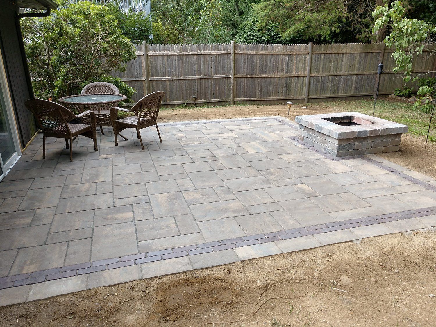 There is a fire pit in the middle of the patio