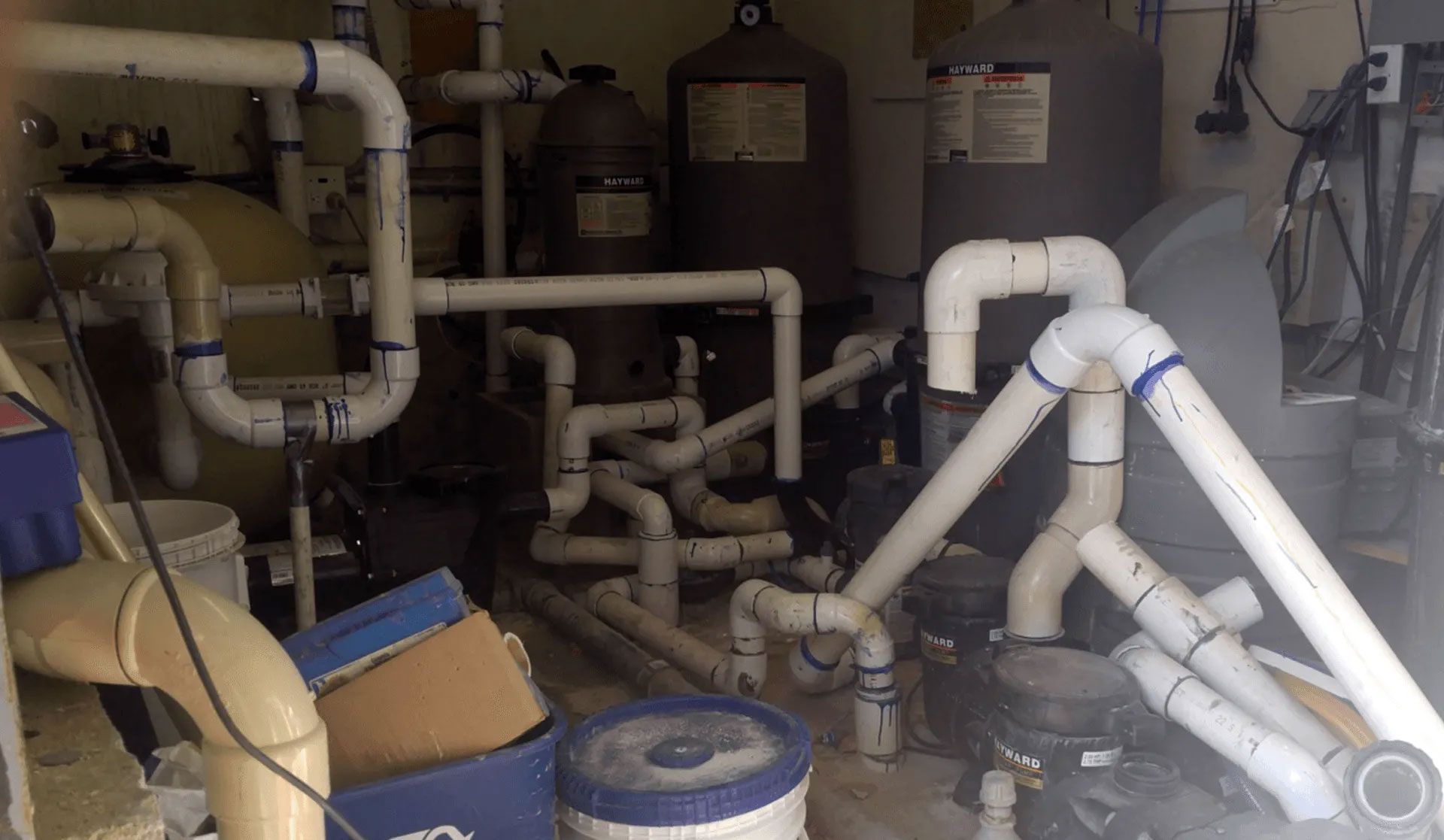 A bunch of pvc pipes are stacked on top of each other in a room.