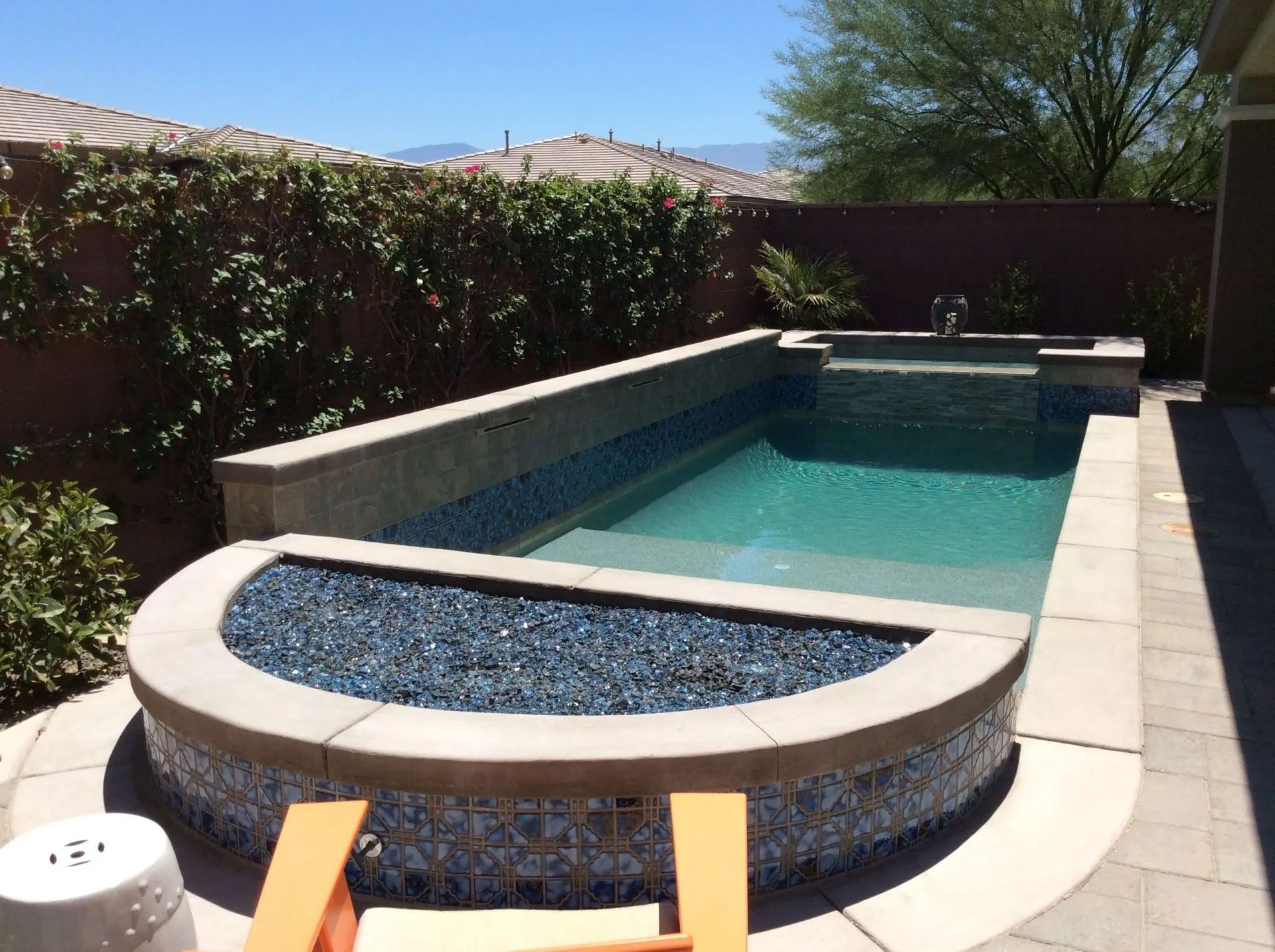 A swimming pool with a hot tub in the middle