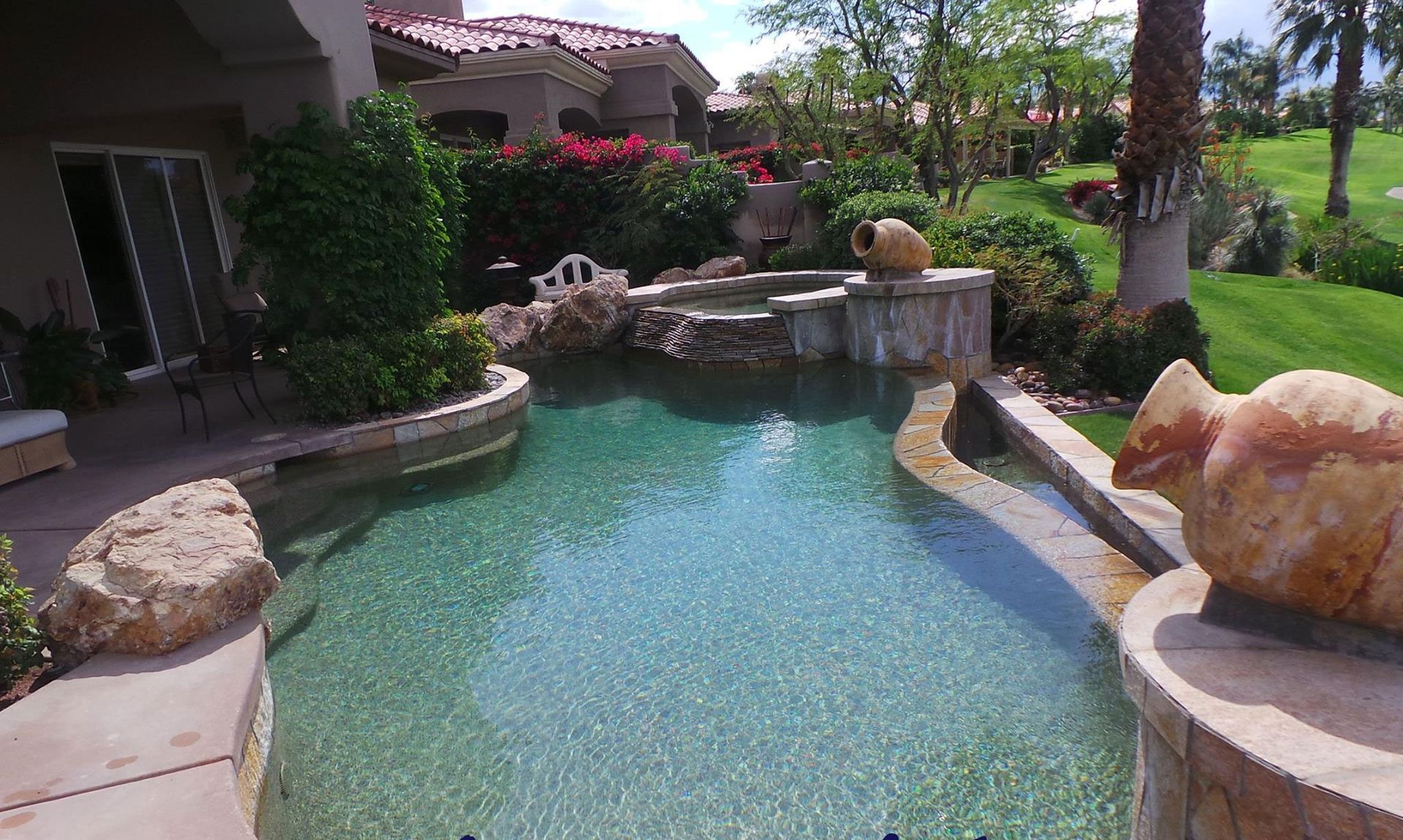 A large swimming pool in the backyard of a house