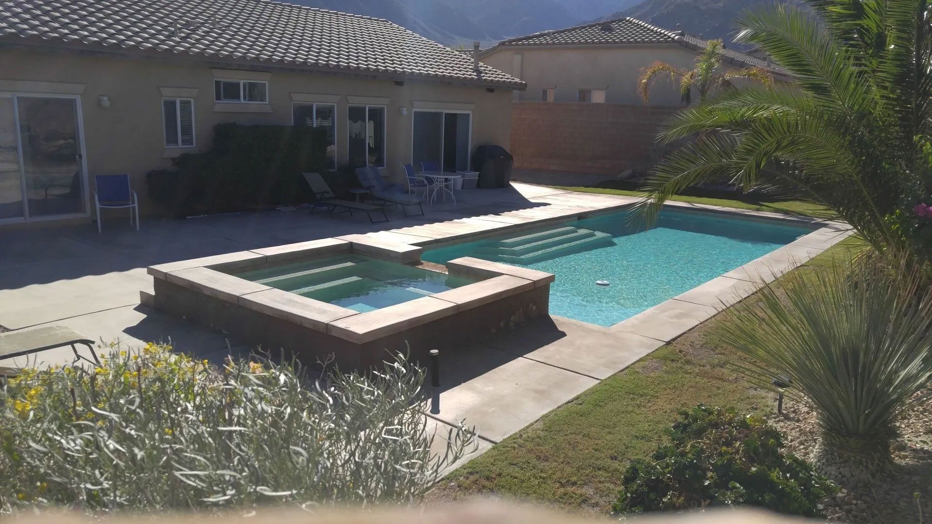 A large swimming pool in the backyard of a house