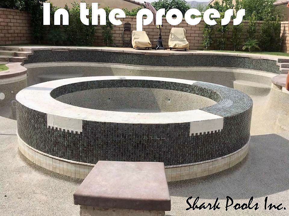 A picture of a swimming pool with the words in the process shark pools inc.