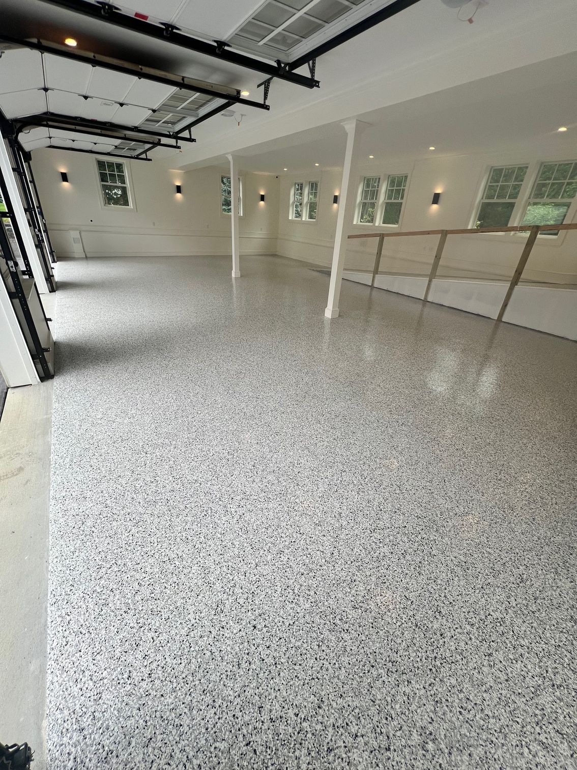 Shea Stadium logo on a walkway, with two people walking away.