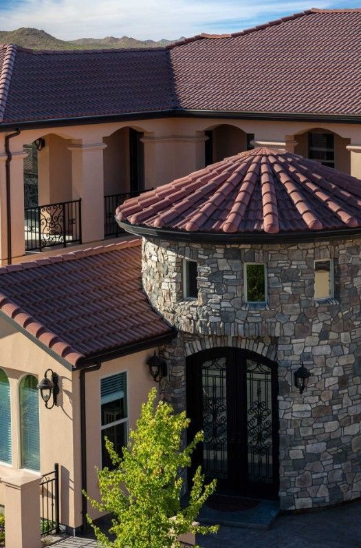 An aerial view of a large house with a tiled roof