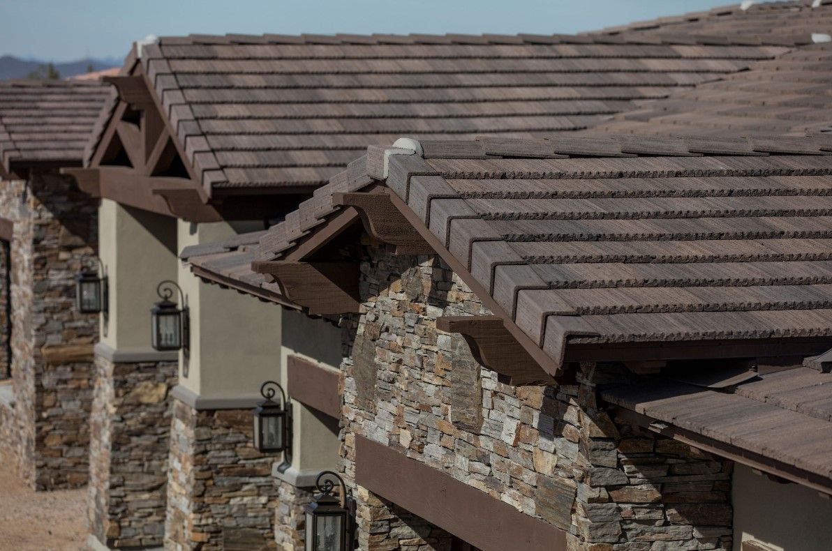 A row of houses with a tiled roof and stone walls.