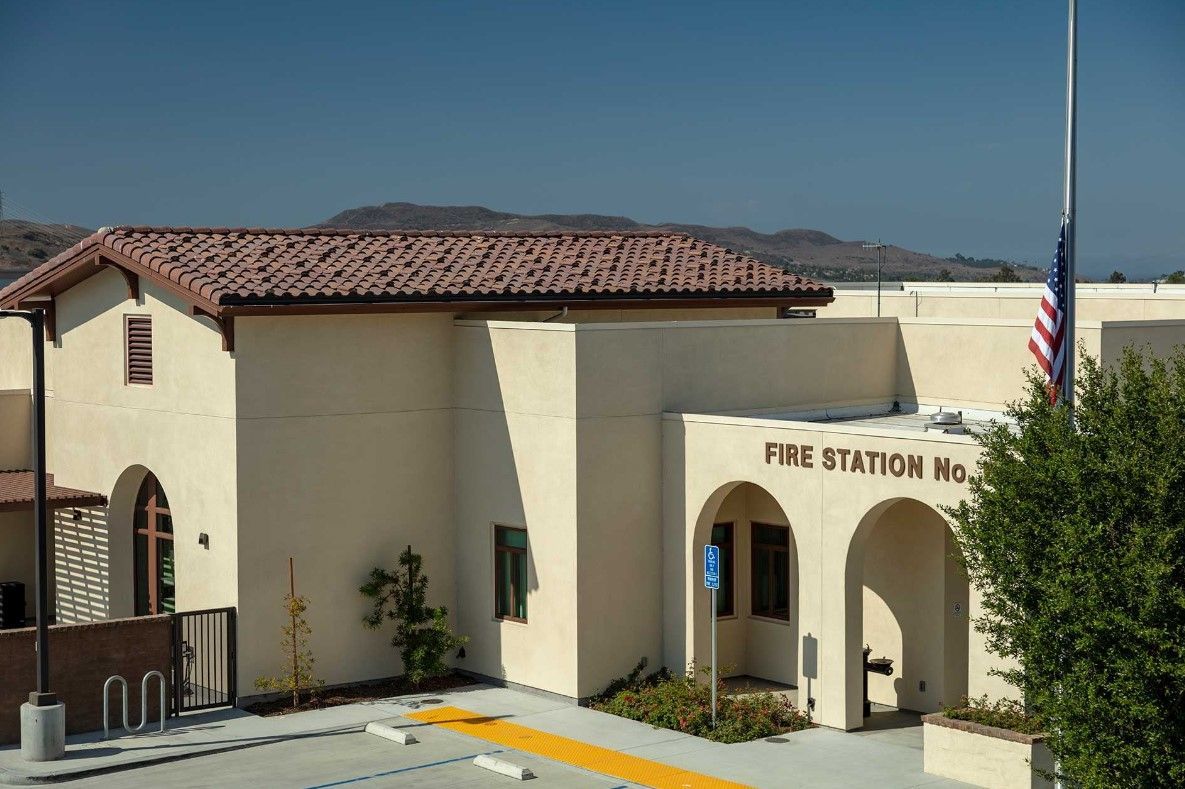A fire station with a flag in front of it