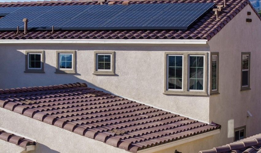 A house with solar panels on the roof and windows