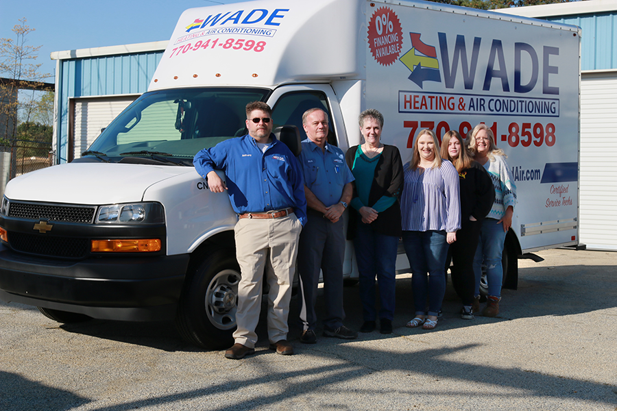 A group of people standing in front of a wade van