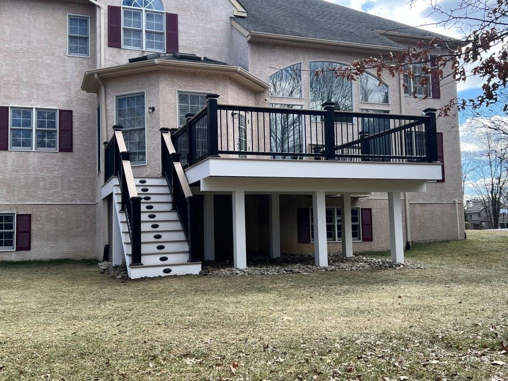 A large house with a large deck and stairs