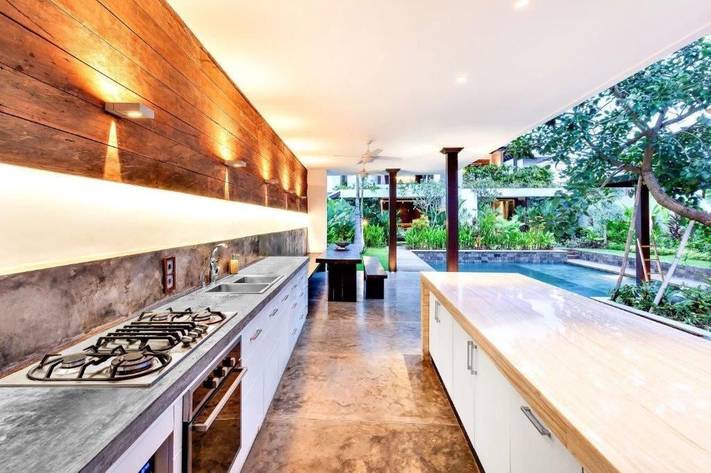 A kitchen with a stove top oven and a sink