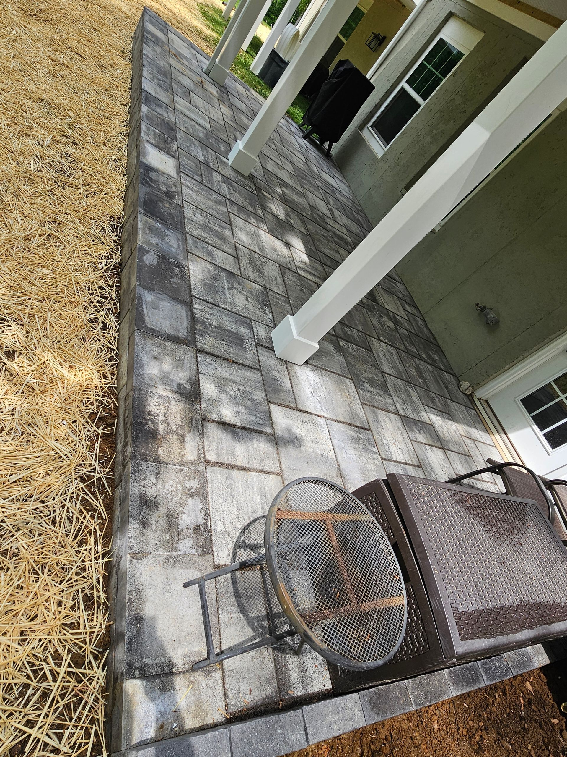 a fire pit on the side of the patio