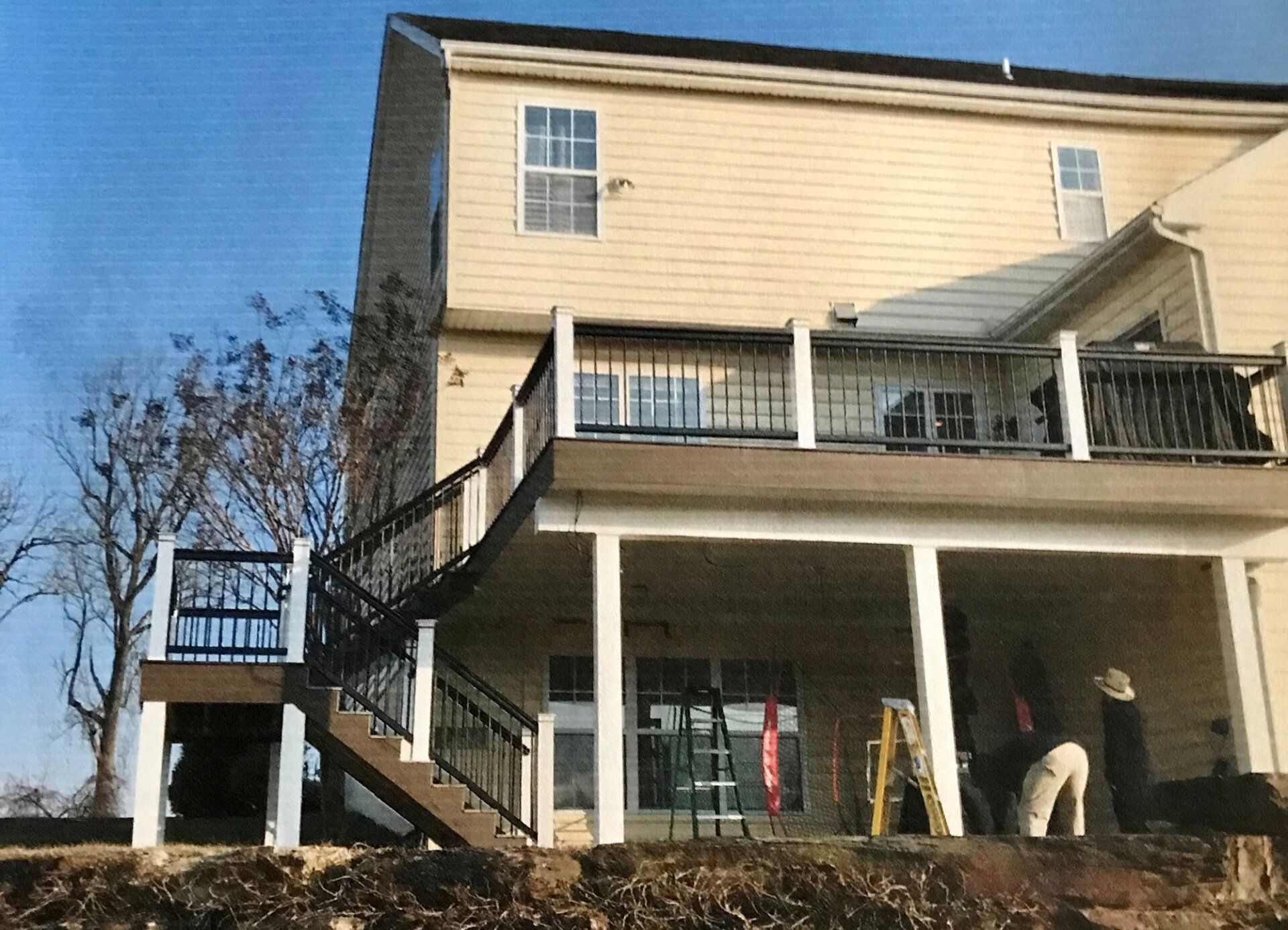 A large house with a large deck and stairs