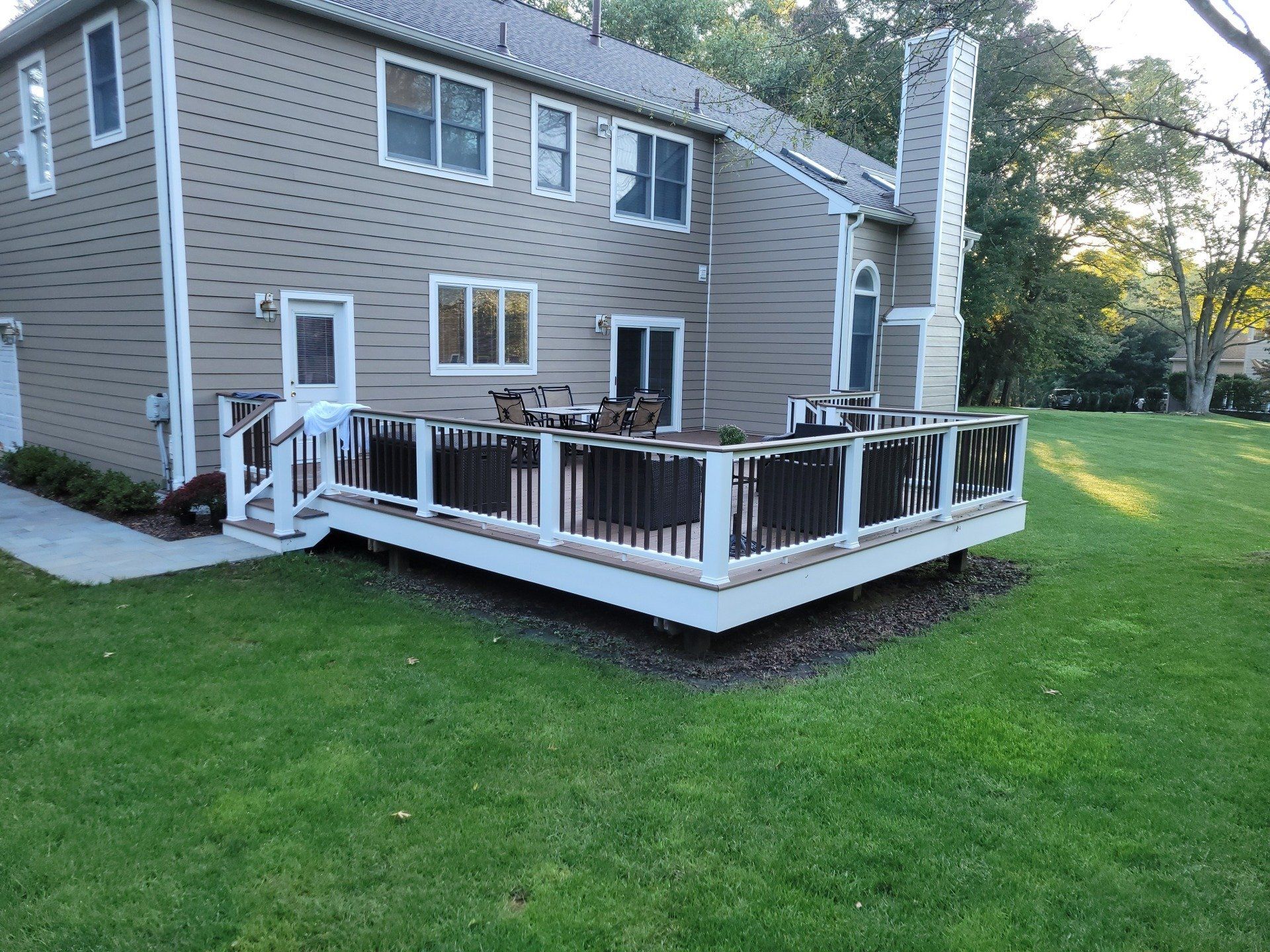 A large house with a large deck in front of it