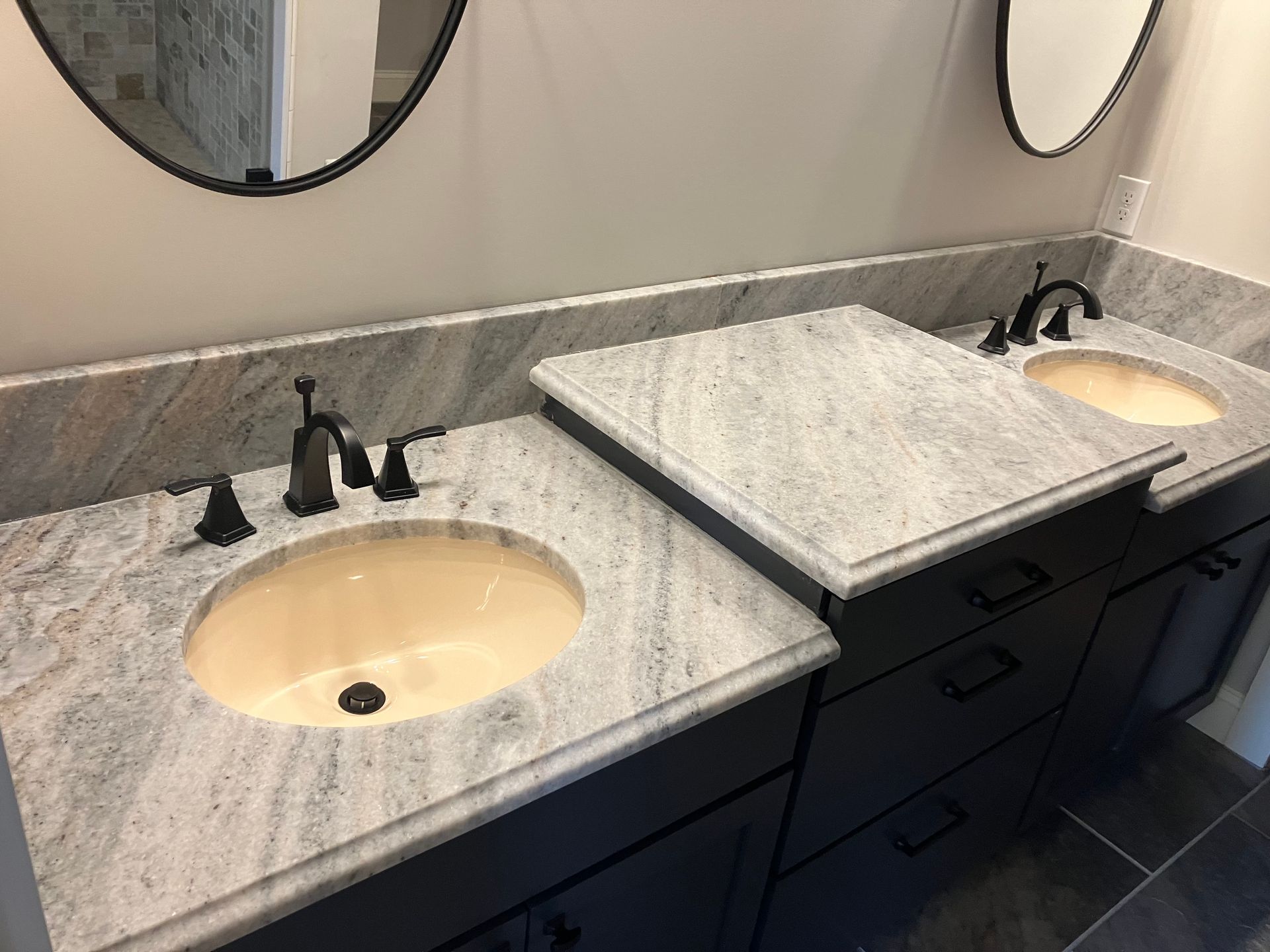 A bathroom with two sinks and two mirrors.