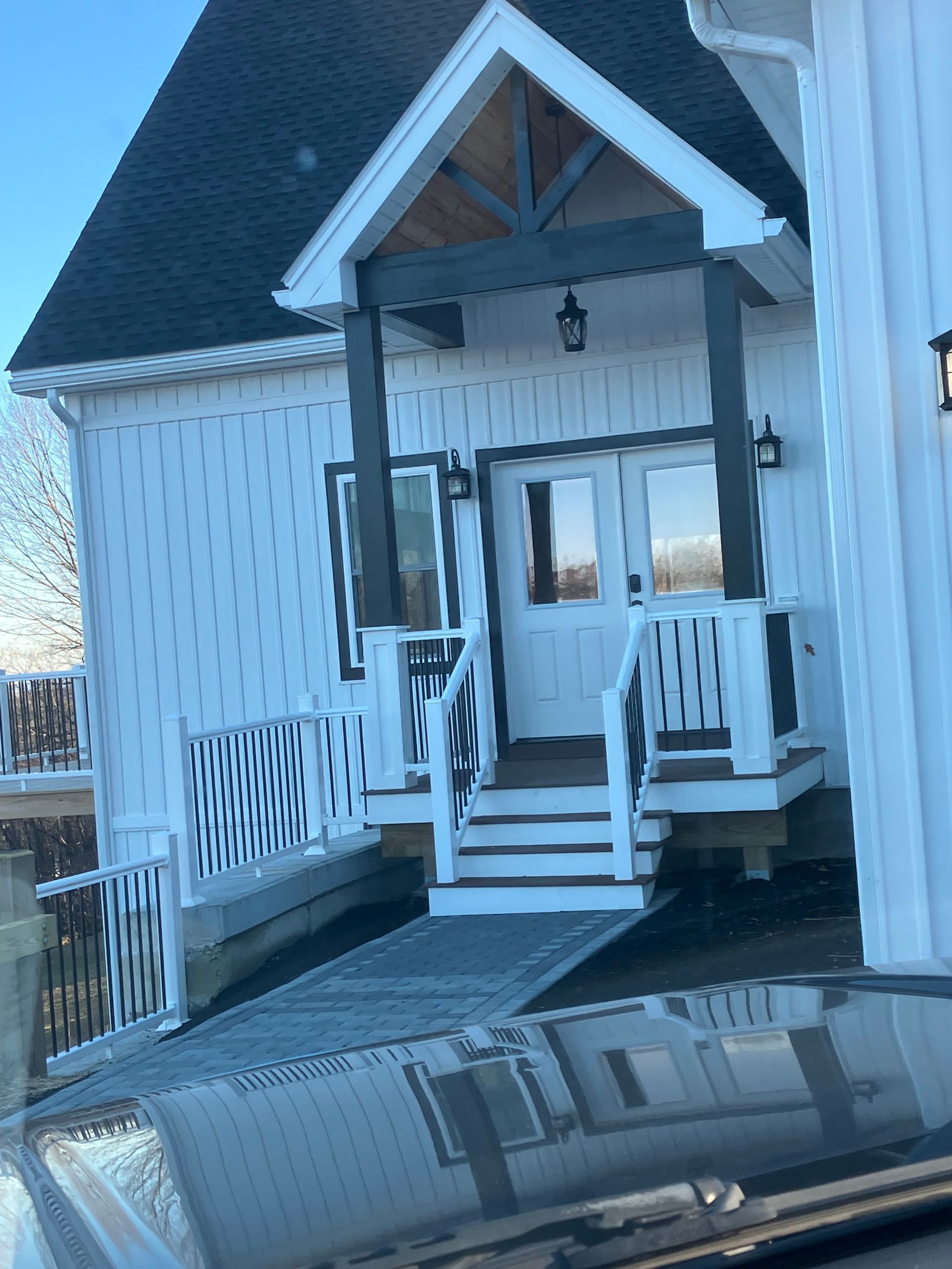 A white house with a ramp leading to the front door
