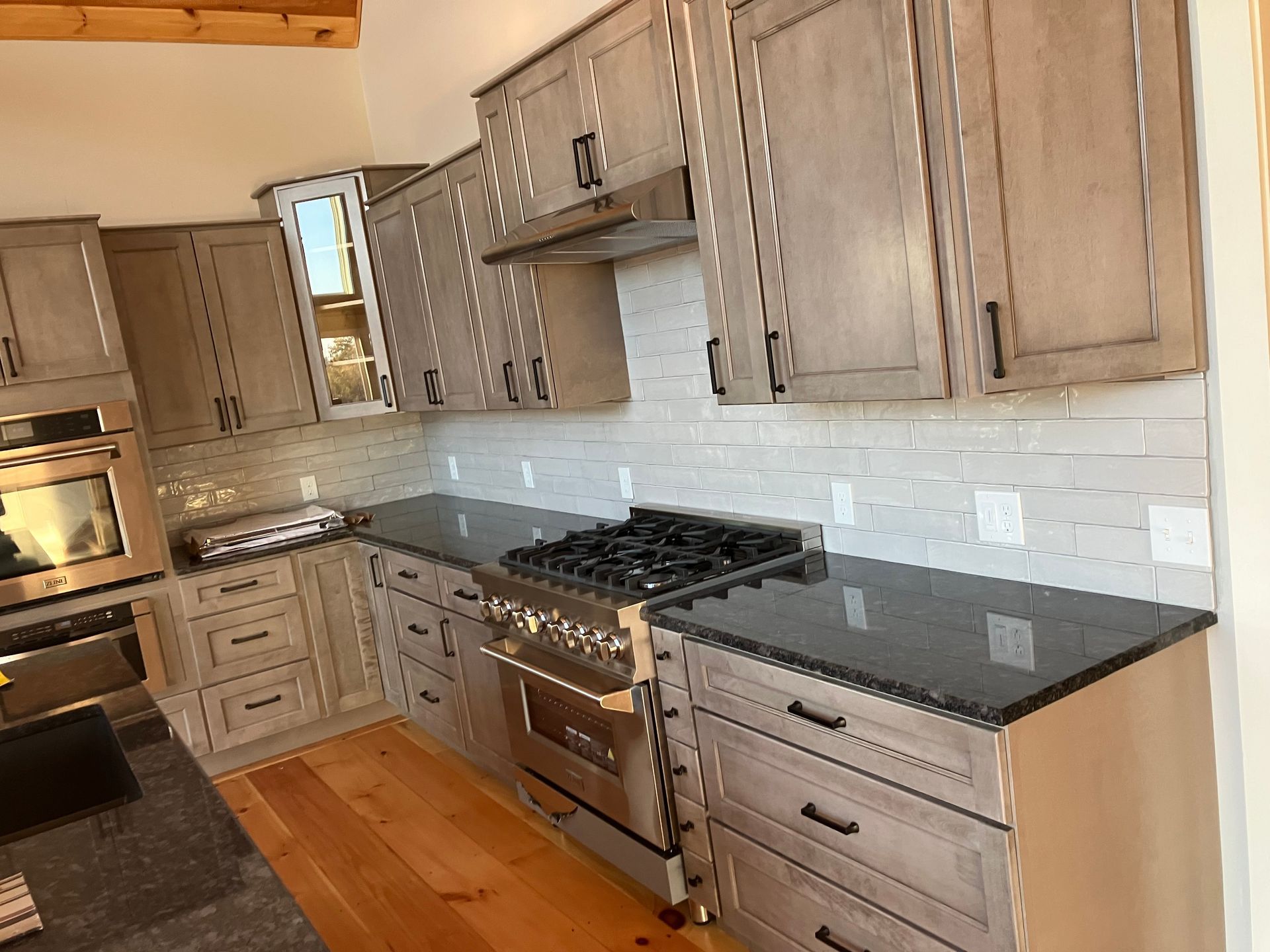 A kitchen with stainless steel appliances and granite counter tops.