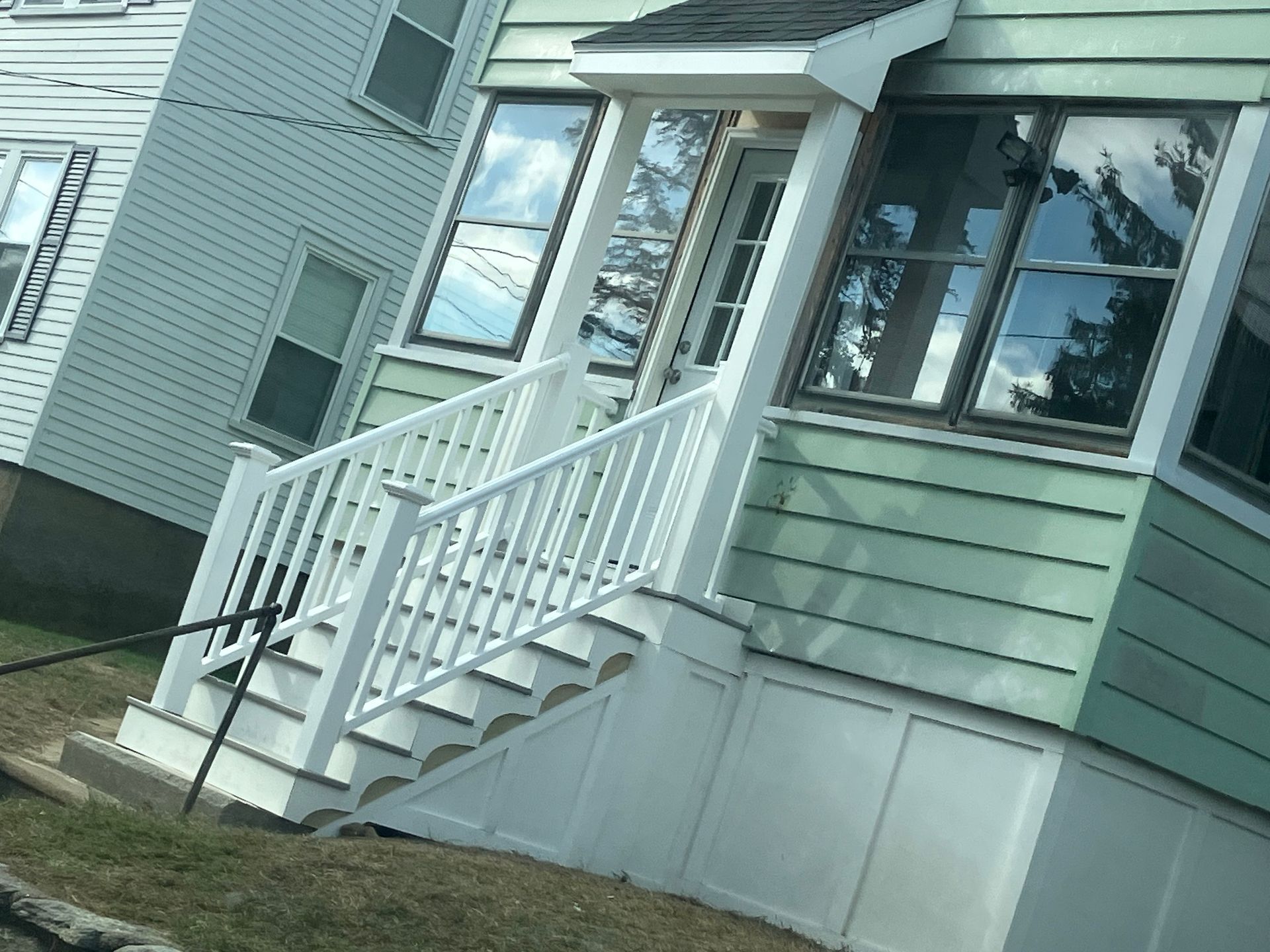 A house with stairs leading up to the front door