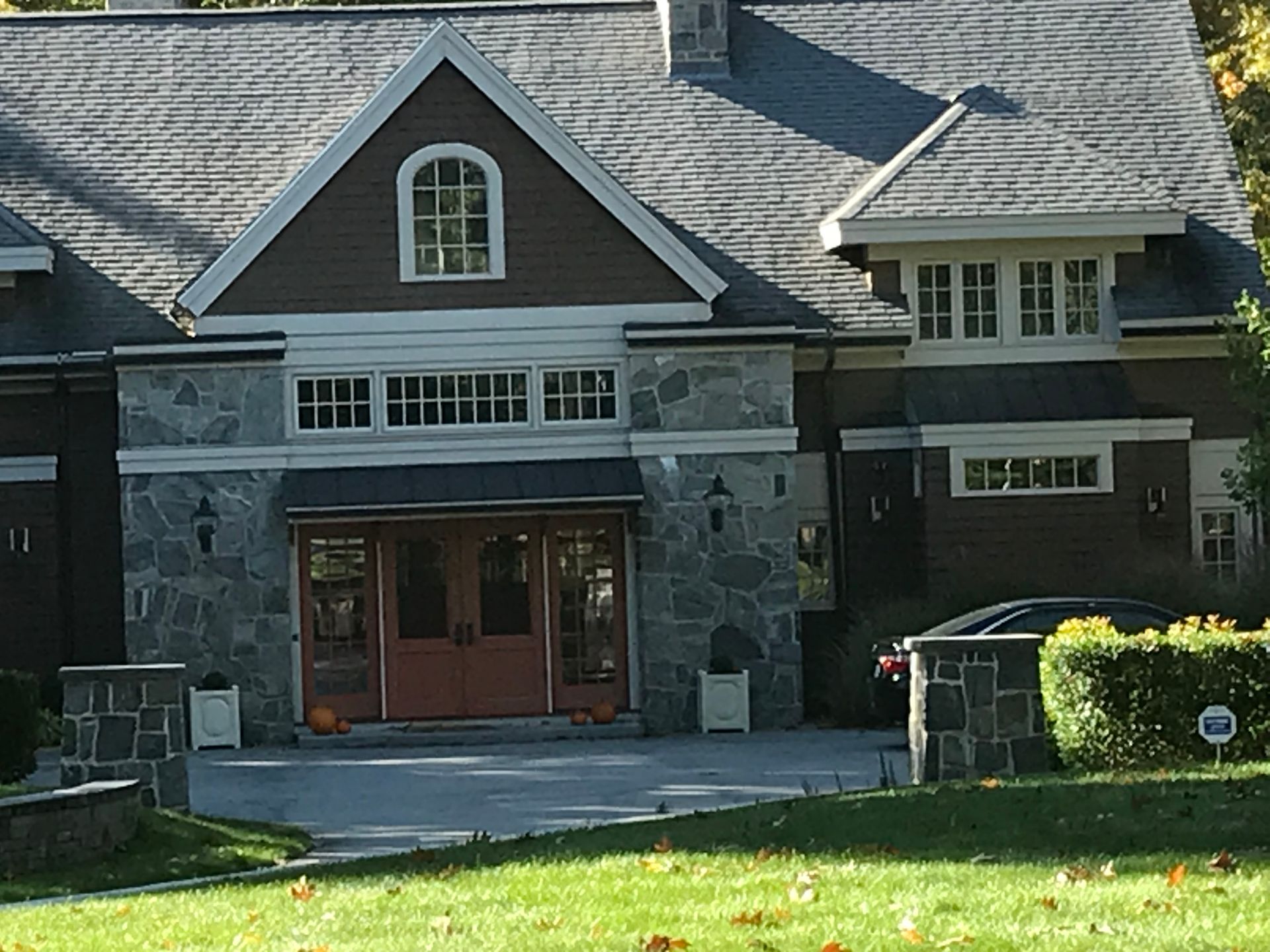 A large house with a car parked in front of it