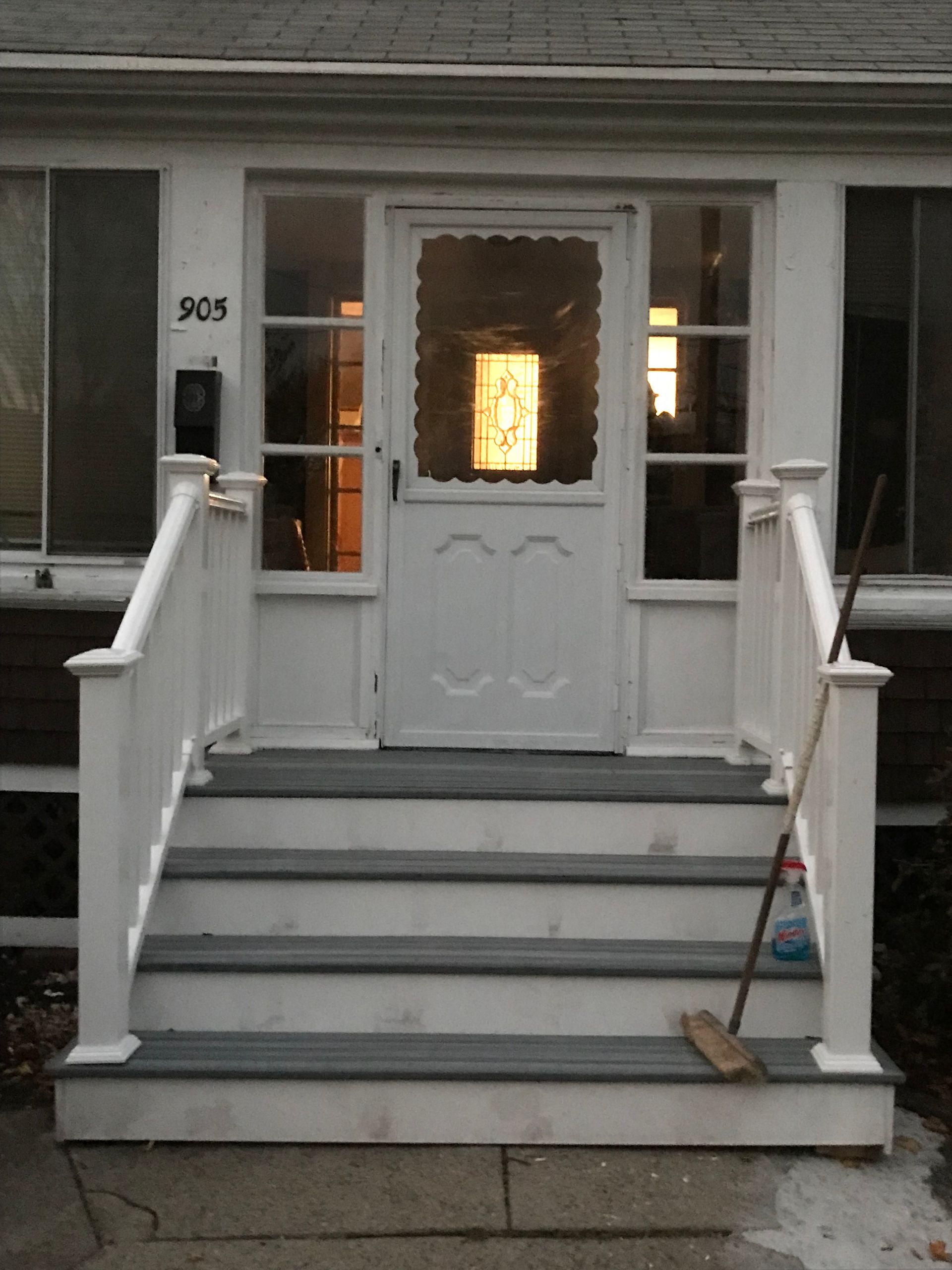 A white house with the number 305 on the front door