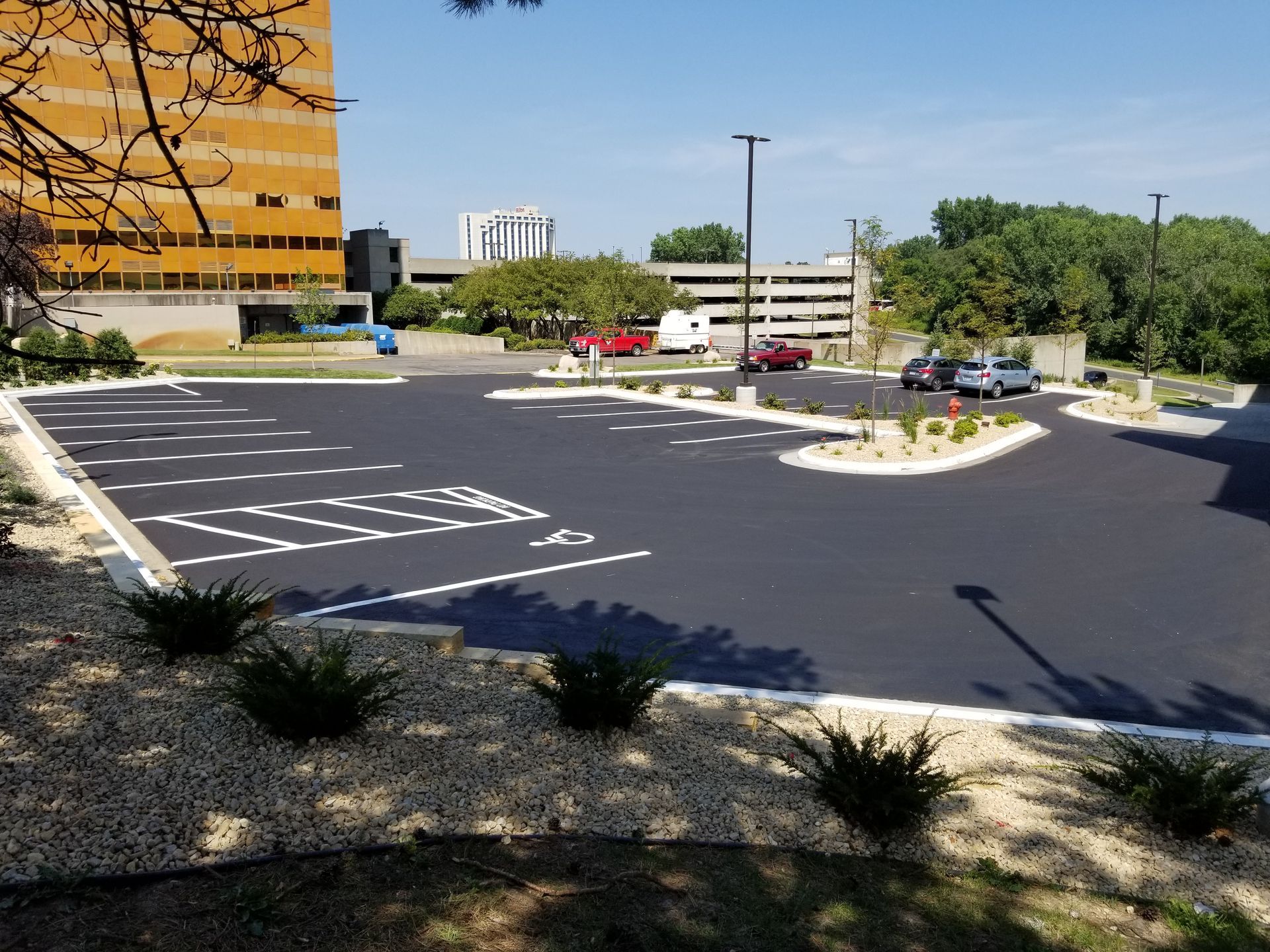 Empty parking lot beside an orange building on a sunny day