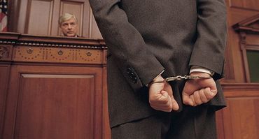 Handcuffed man in court room
