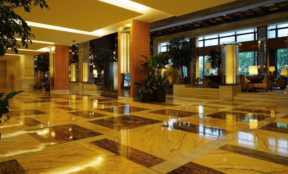 A large lobby of a hotel with a marble floor