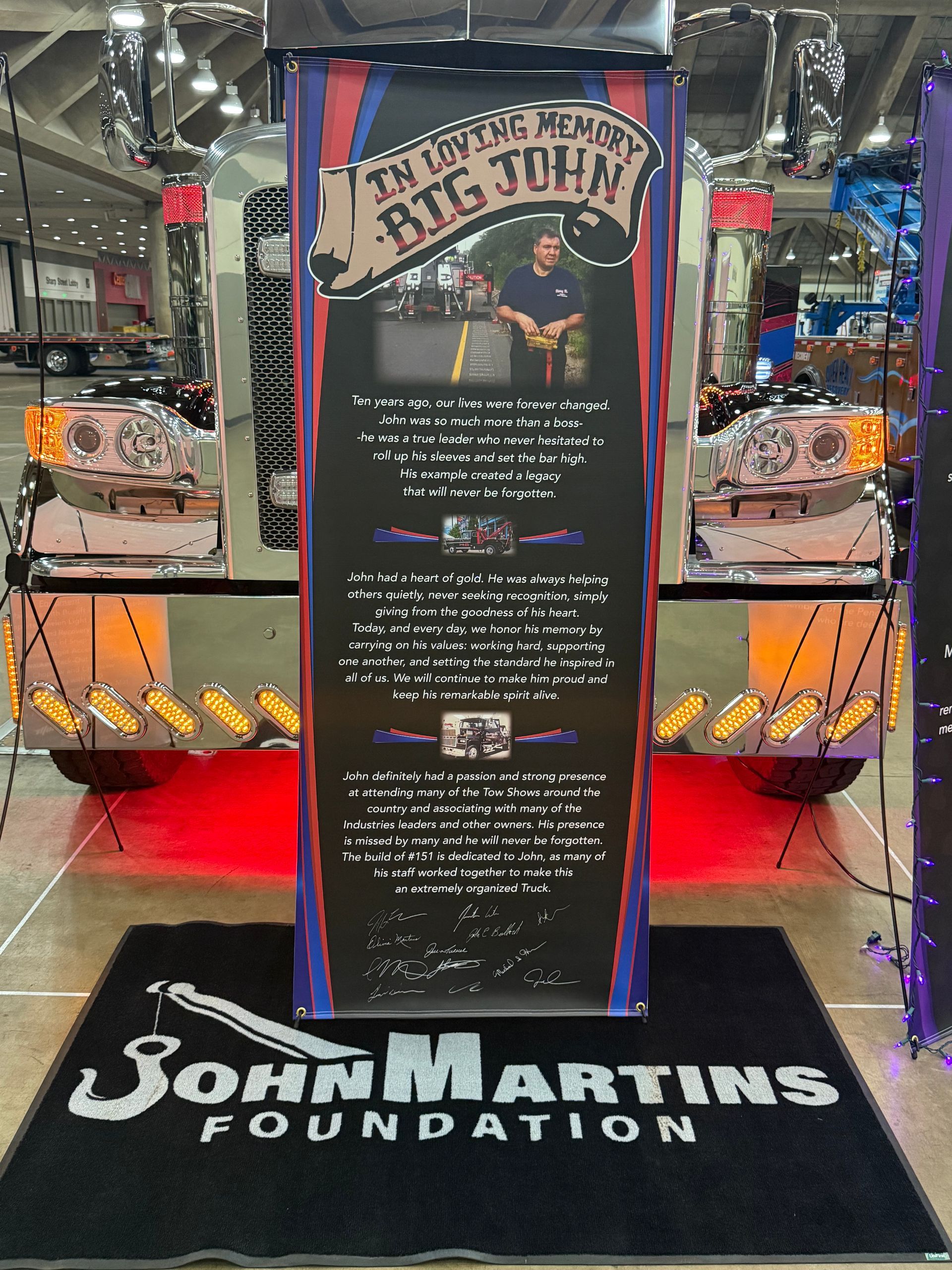 John Martins Foundation donation display with lit vintage car and red carpet at indoor event.