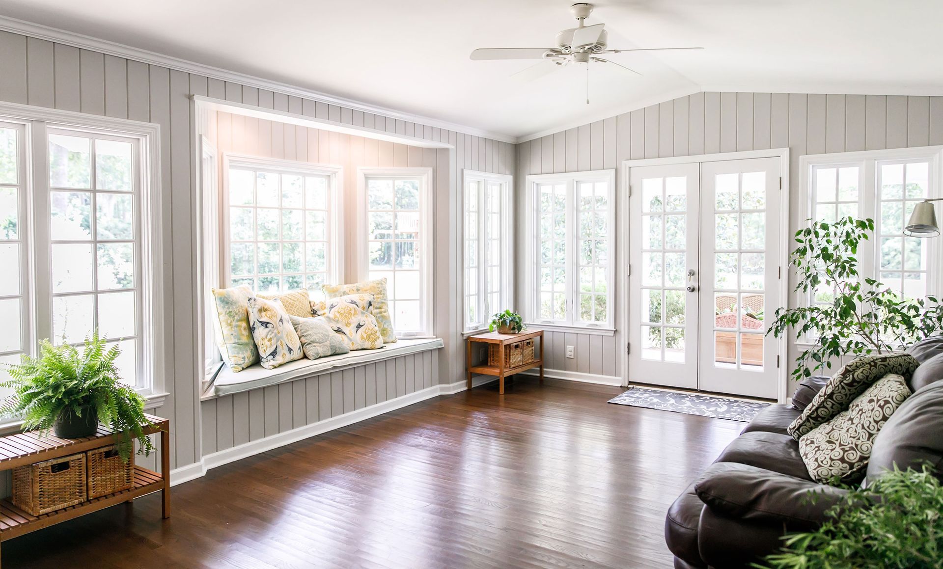 A living room with a couch and a window seat