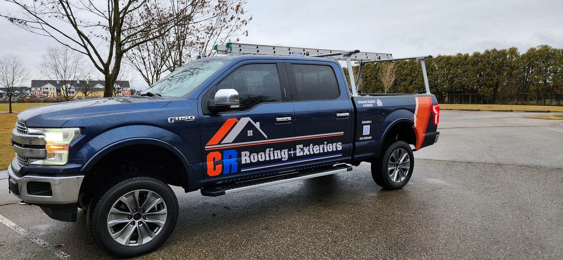 Dark blue pickup truck with ladder rack; 