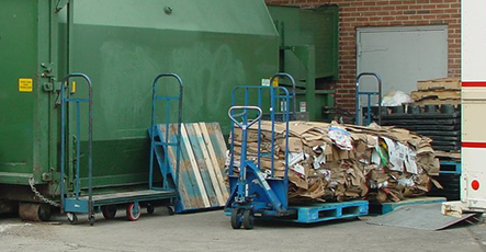 Green dumpster in commercial area