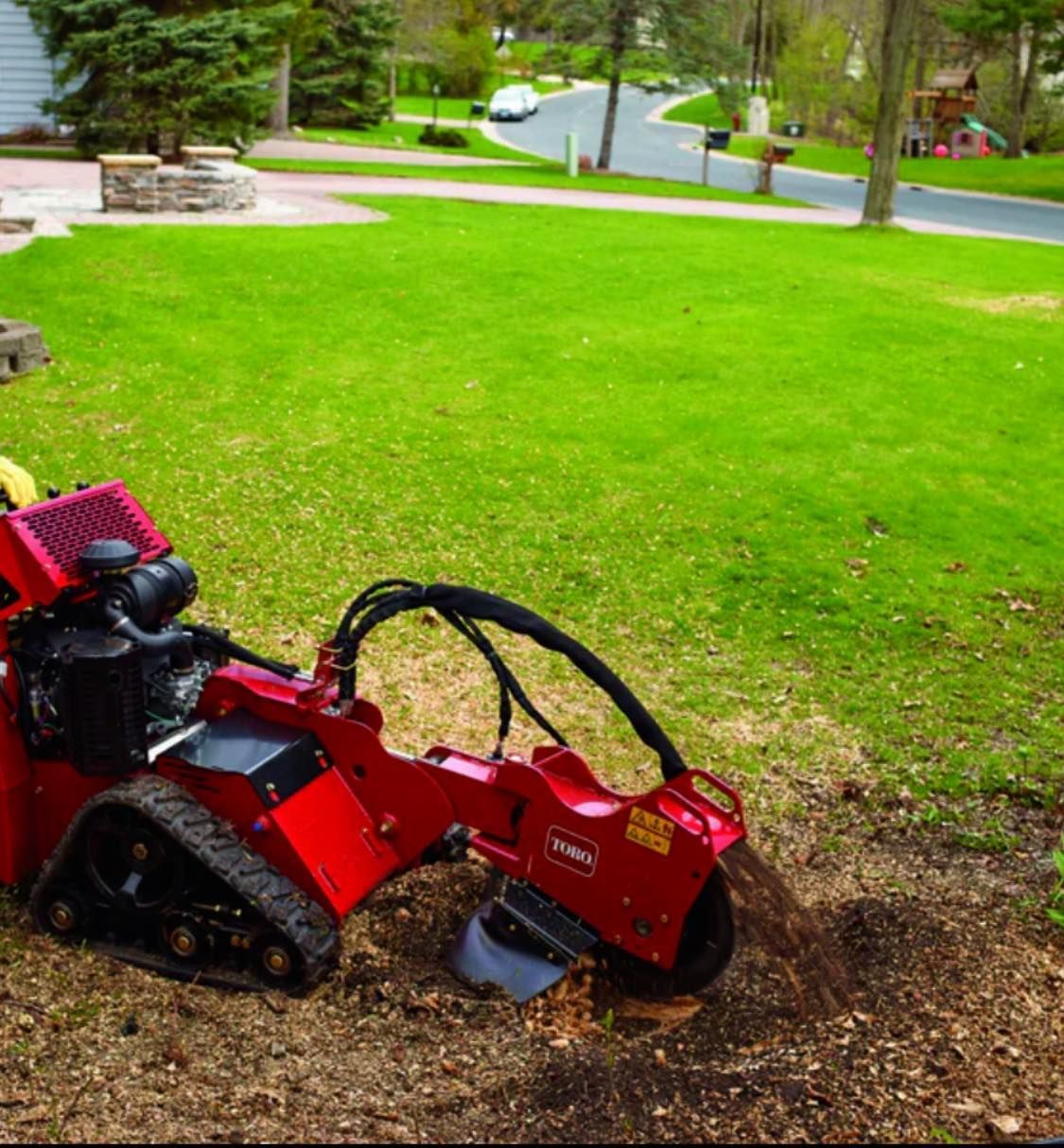 A toro stump grinder is being used to remove a tree stump