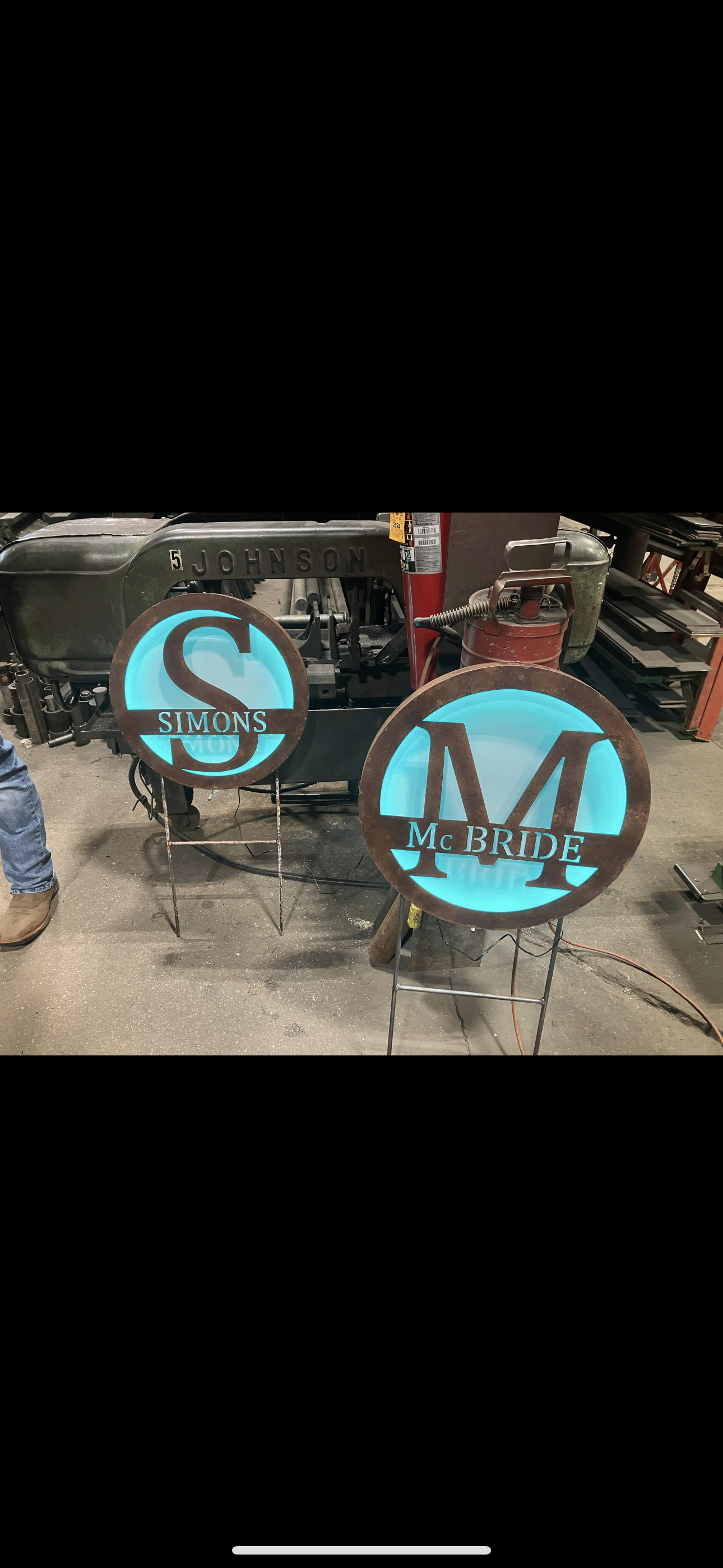 A couple of signs with a monogram on them are sitting on a table.