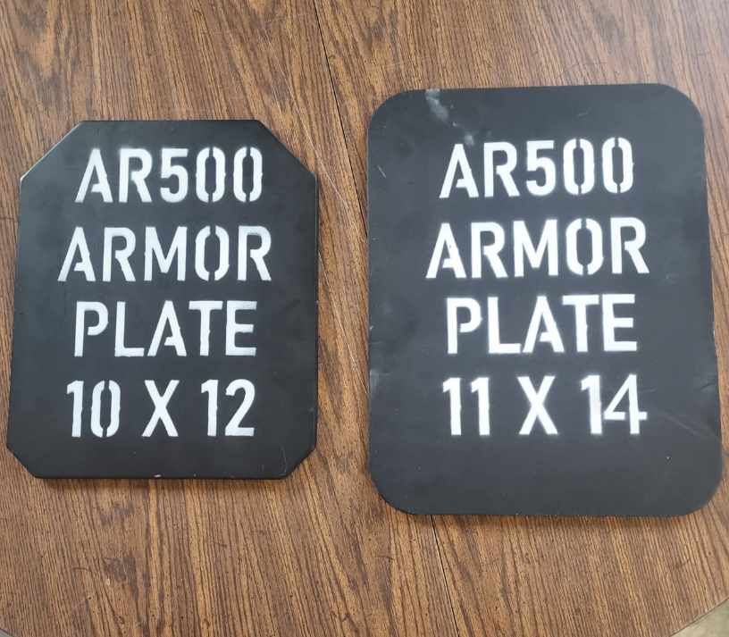 Two ar500 armor plates are sitting on a wooden table