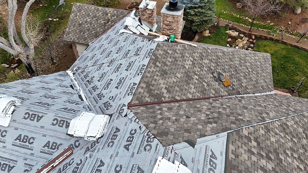 An aerial view of a roof being installed on a house.
