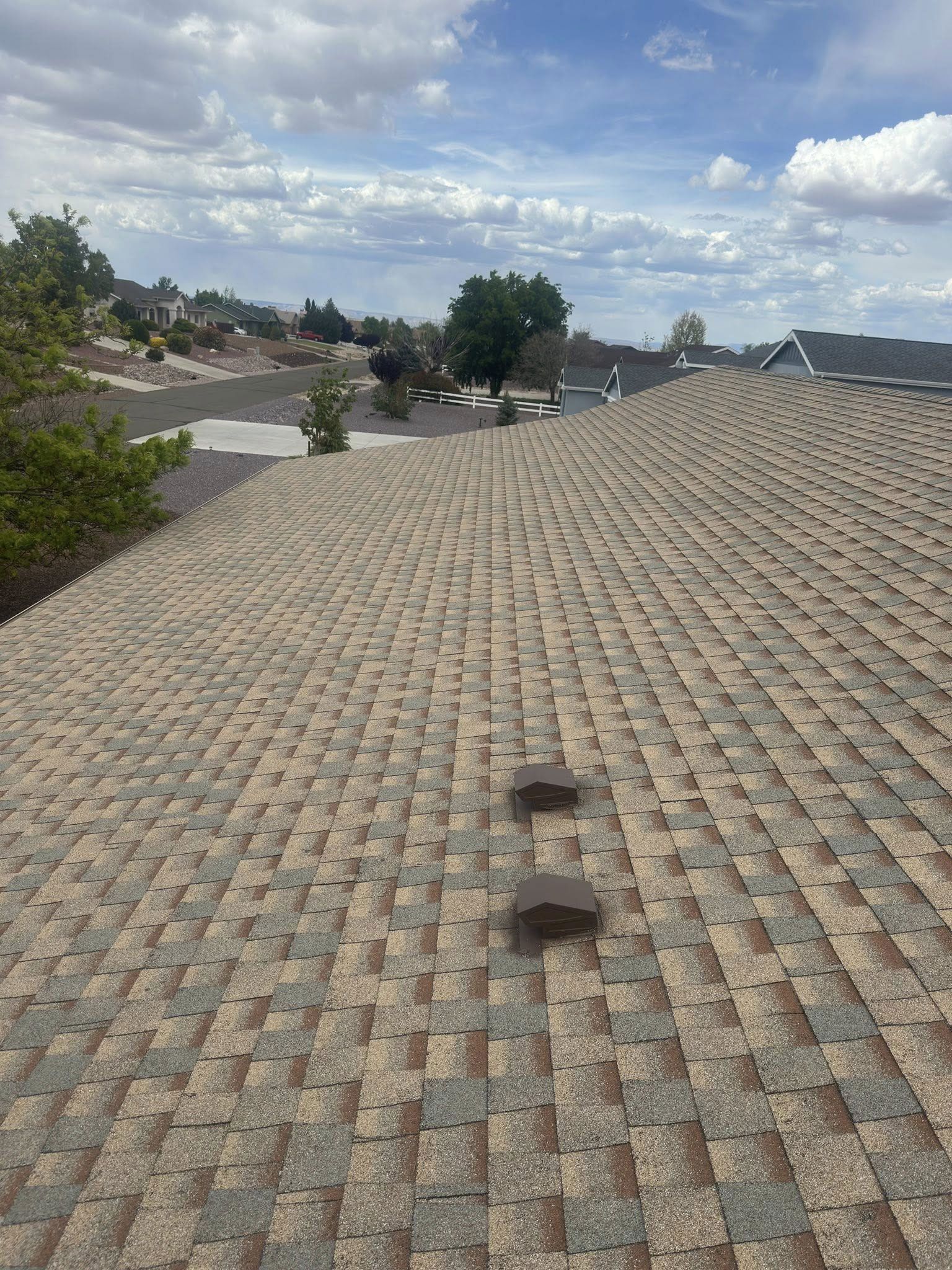 A close up of a roof with a blue sky in the background.