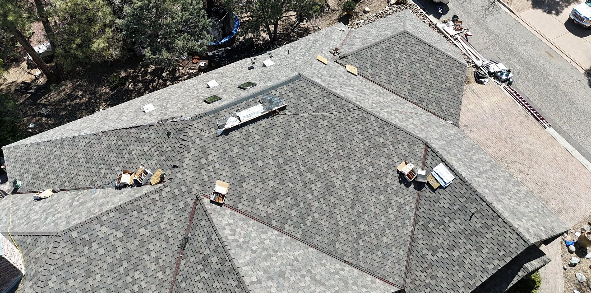 An aerial view of a roof being installed on a house.