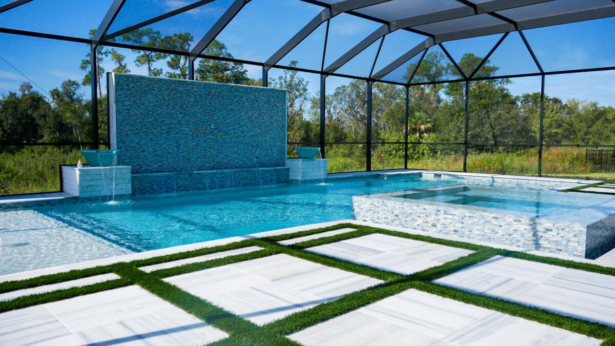 There is a large swimming pool with a waterfall in the background.