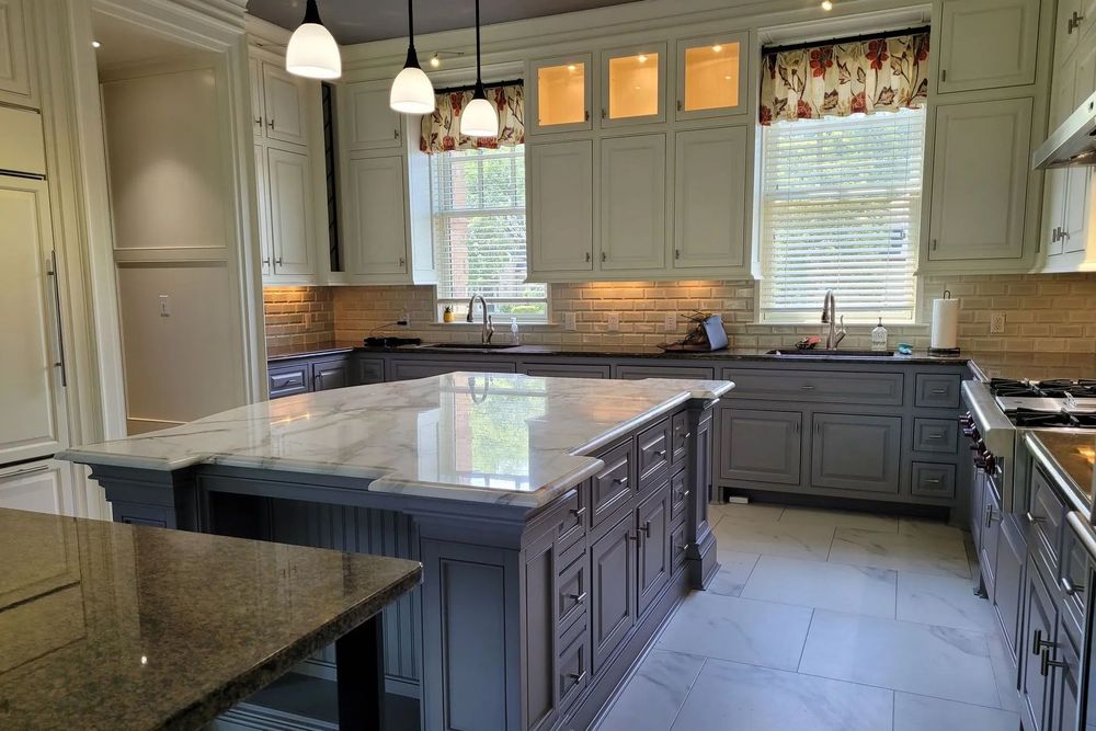 A large kitchen with a large island in the middle of it.
