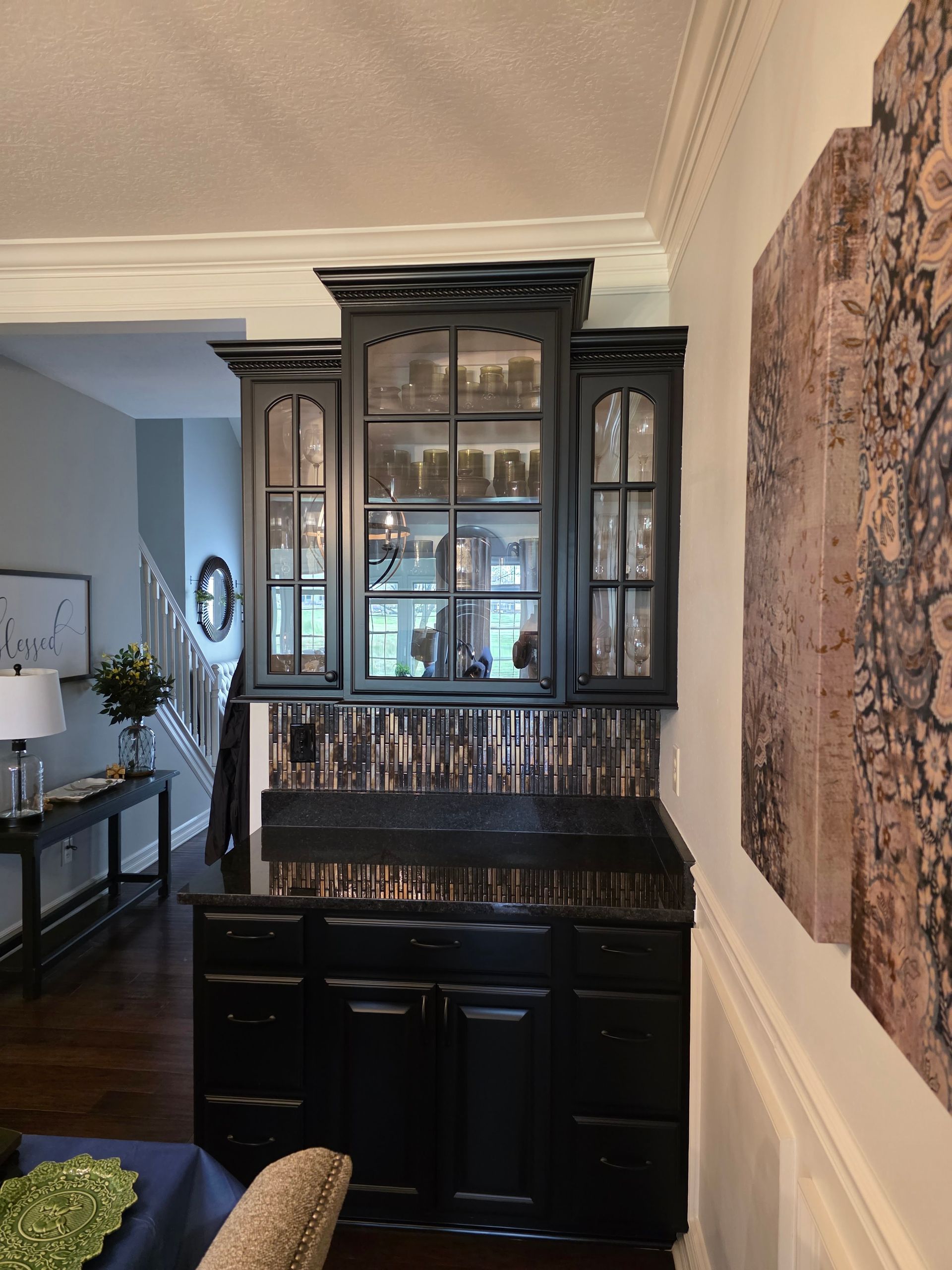 A living room with black cabinets and glass doors