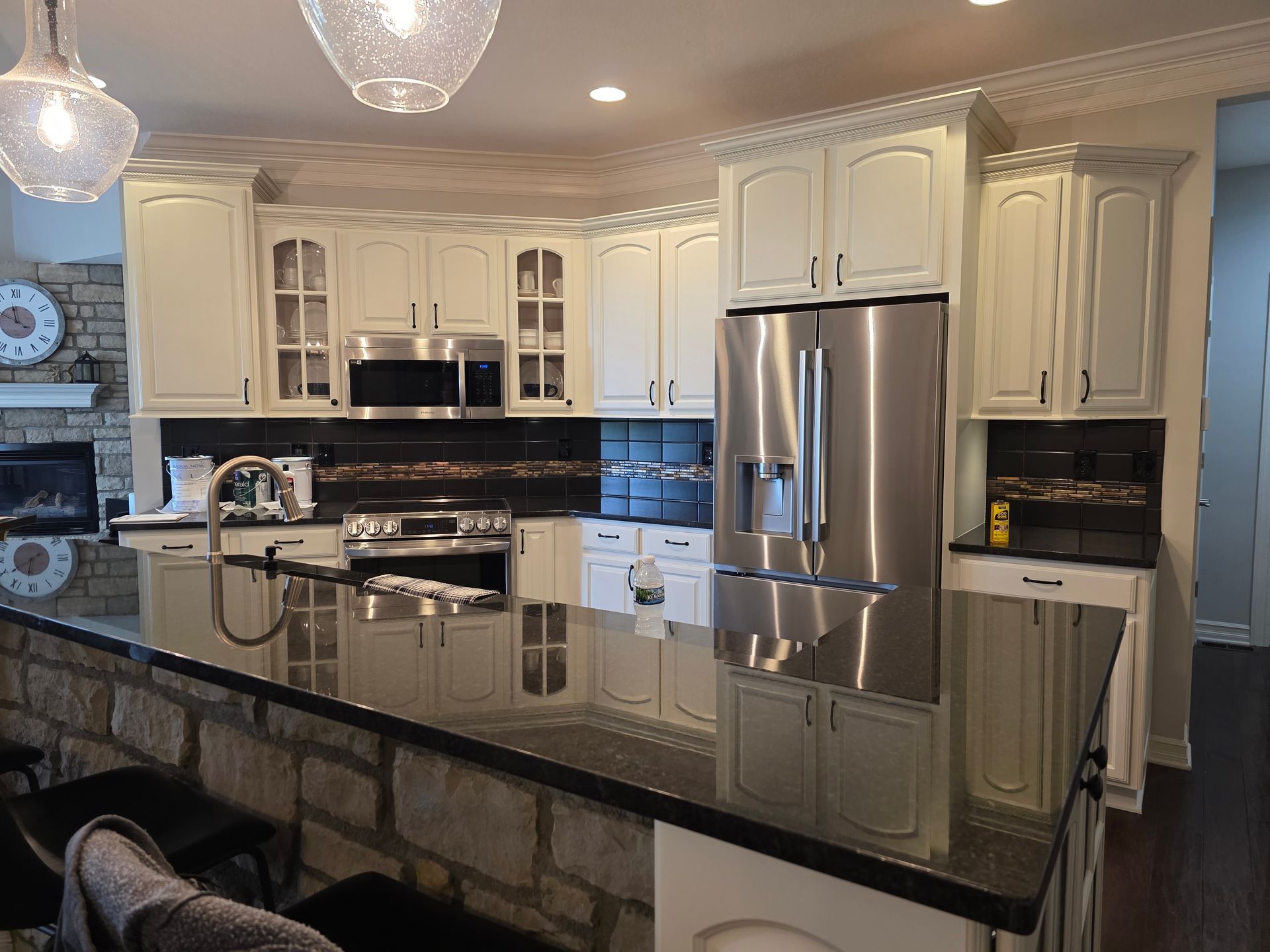 A kitchen with white cabinets and stainless steel appliances