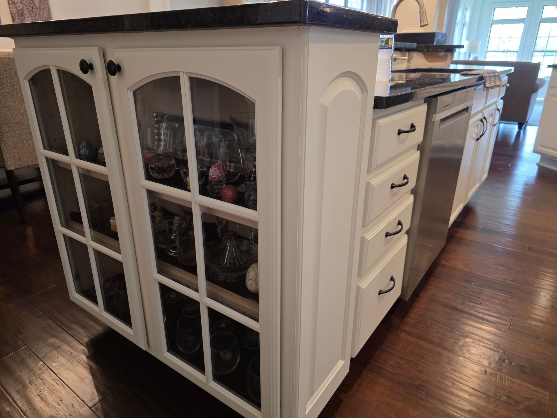 A kitchen with white cabinets and stainless steel appliances.