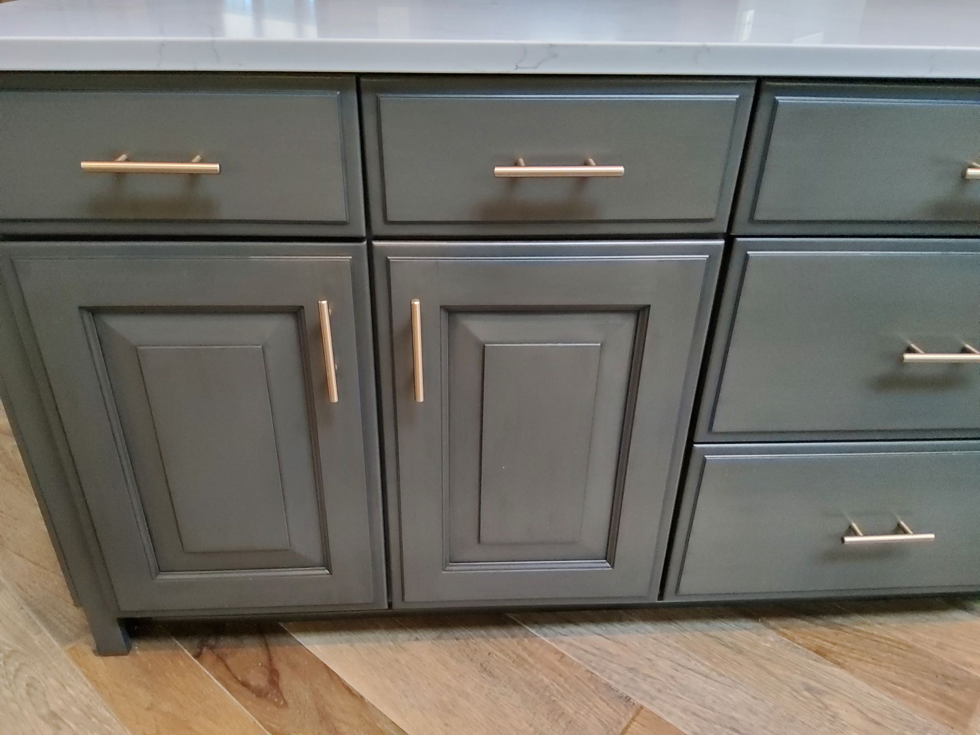 A close up of a cabinet with drawers and doors in a kitchen.