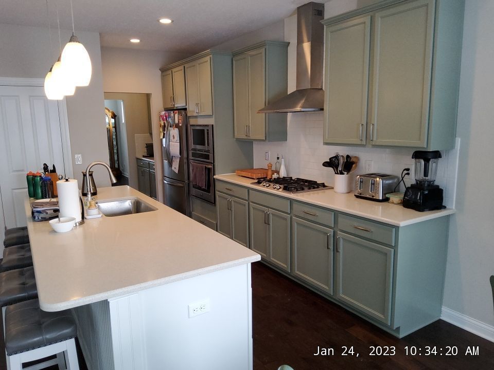 A kitchen with stainless steel appliances and wooden cabinets