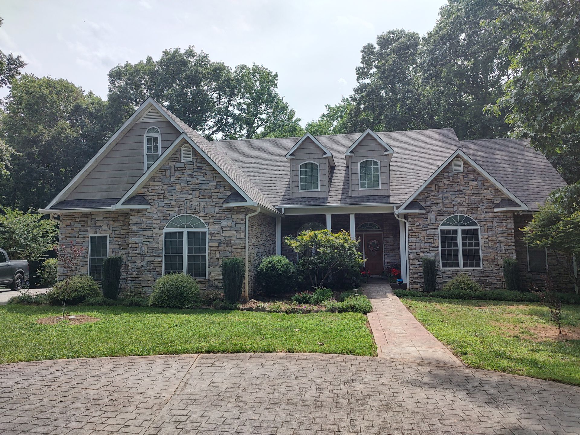 A large brick house with a gray roof
