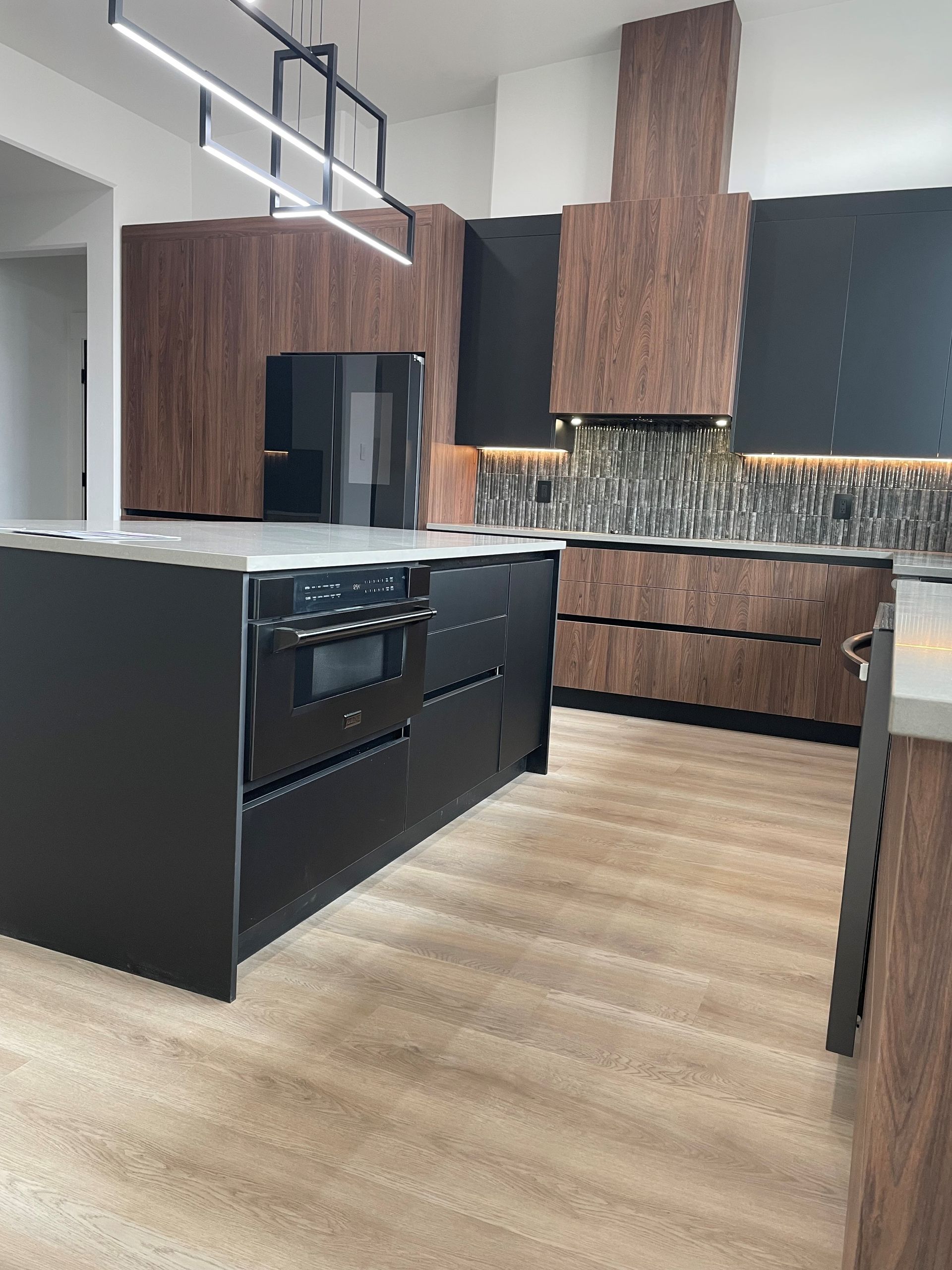 A kitchen with stainless steel appliances and wooden cabinets